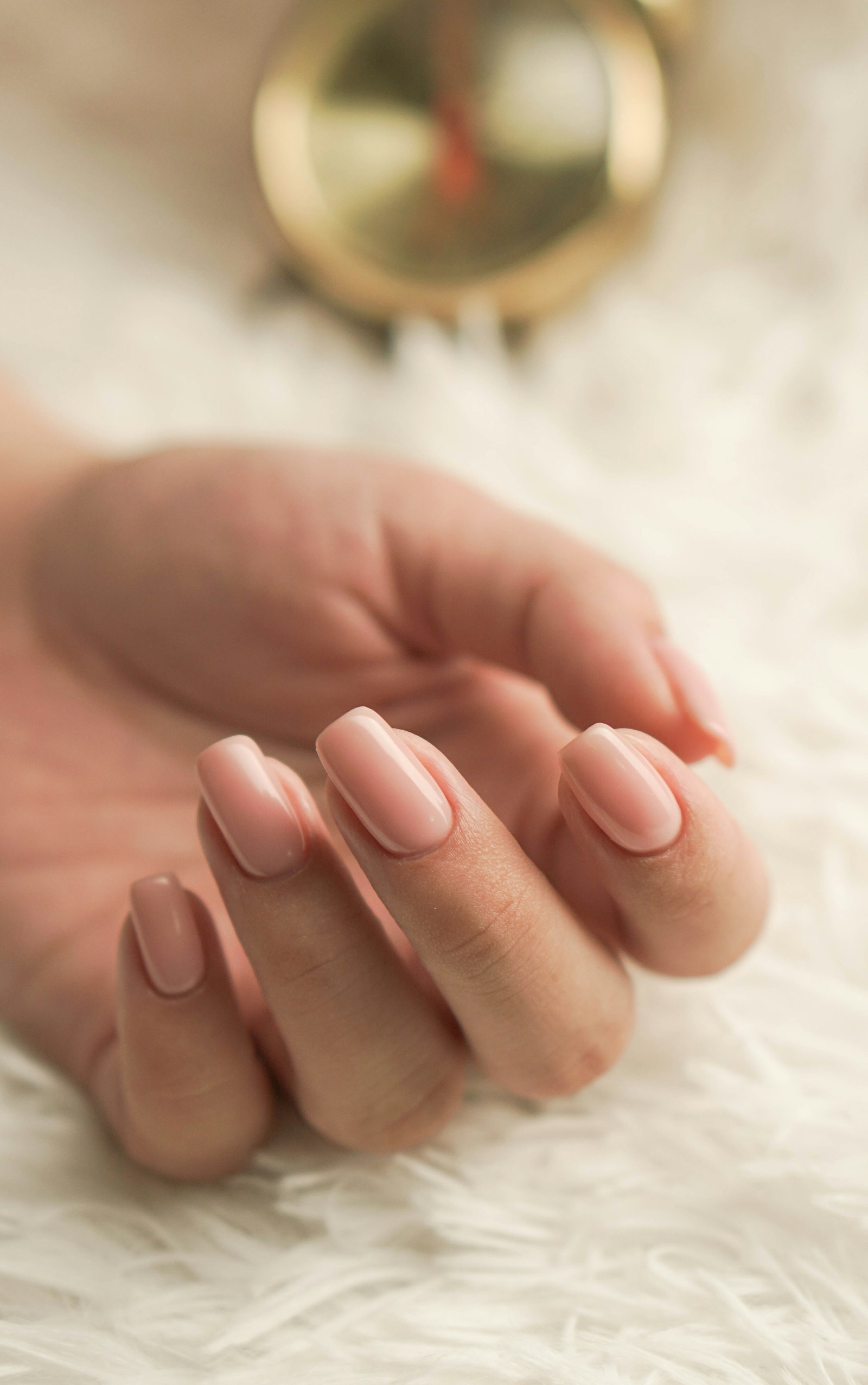 Manicure con smalto nude elegante e finitura lucida